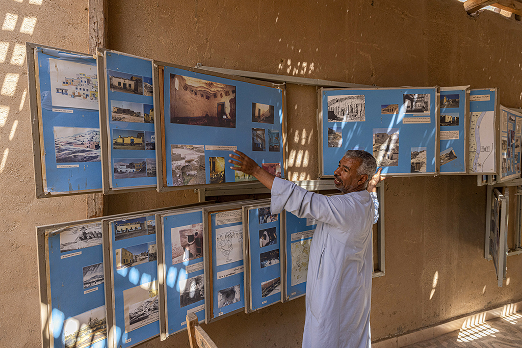 Abdel Hamid Osman Taia Daramalli, a local, shows images displaying the history of his village of Al-Qurna (Gurna) at a private museum there on the west bank of the Nile river opposite Egypt's southern city of Luxor.