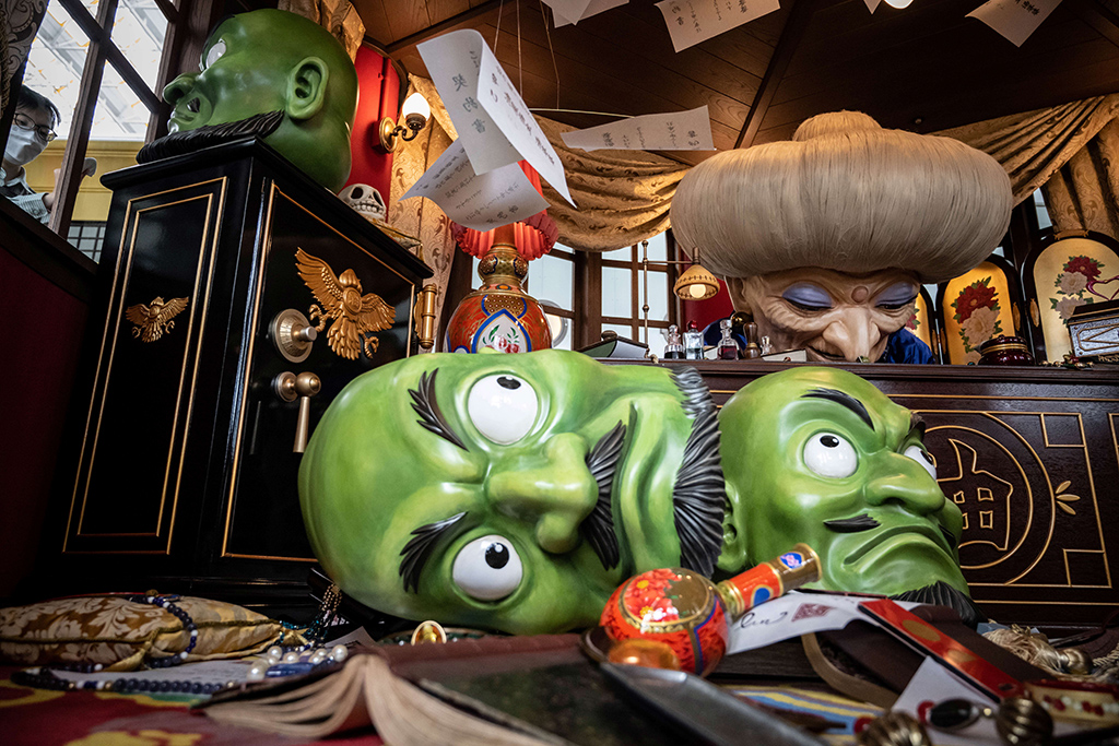 A member of staff (left) cleans a window of an exhibit at Ghibli's Grand Warehouse during a media tour of the new Ghibli Park.
