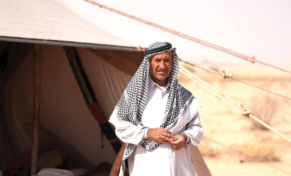 Farmer Hussein Badiwi, 60, is pictured in front of his tent on the edge of the desert of Iraq's central city of Najaf.