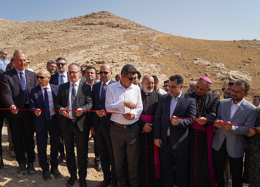 Attendees including Italian archaeologist Daniele Morandi Bonacossi (left), Italian ambassador in Iraq Maurizio Greganti (third left), Governor of Dohuk Ali Tatar (center), Bishop of the Chaldean Diocese of Alqosh Mar Boulos Thabet (second right), and Director of Antiquities of Dohuk Governorate Bekas Brefkany (right), take part in a ribbon-cutting ceremony for the opening of the first phase of a planned archaeological park in the ancient site of Faydeh (Faida). 