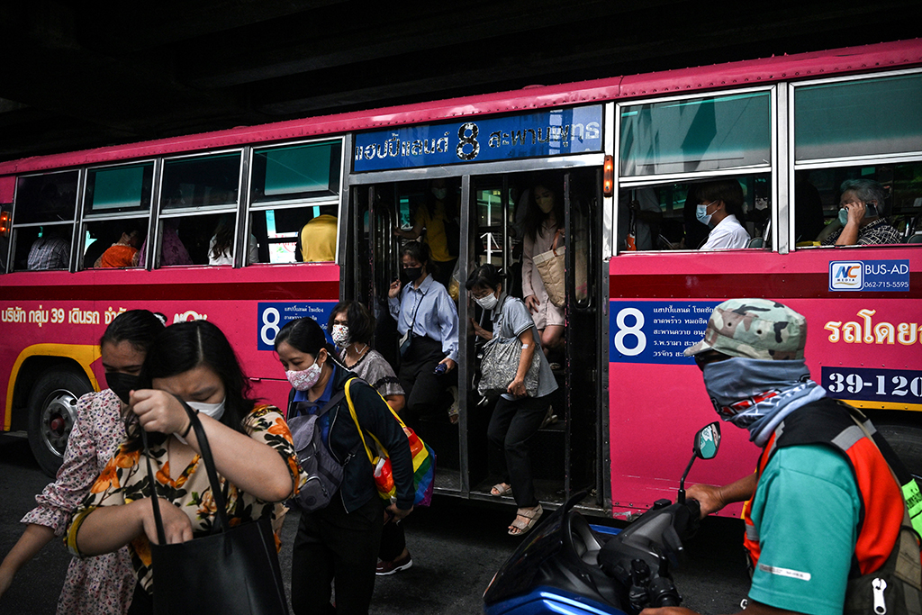 Passengers alighting a No.8 bus in Bangkok.