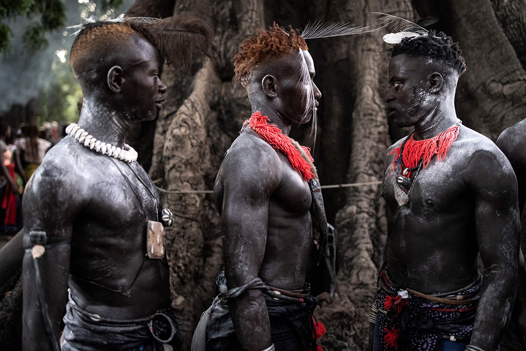 Young men, dressed in their traditional outfits, attend a ceremony marking the end of the yearly initiation process for young men in Kabrousse.