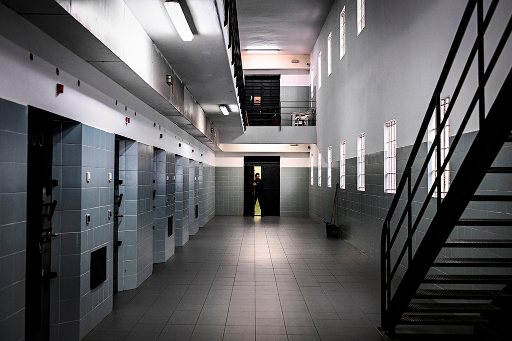 A prison guard stands near the prison cells at Linho prison.