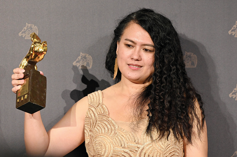 Taiwanese director Lana Mebow poses for pictures after winning the Best Director award with her film 