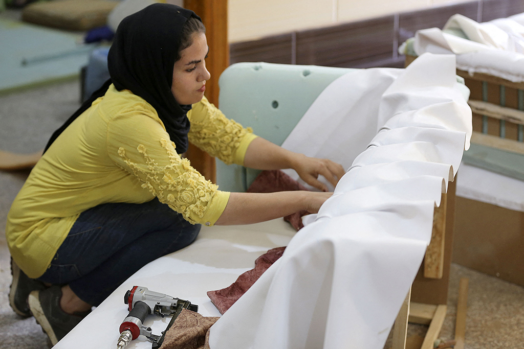 Iraqi carpenter Nour Al-Janabi works at her home furniture workshop in Baghdad's Abu Dsheer area.
