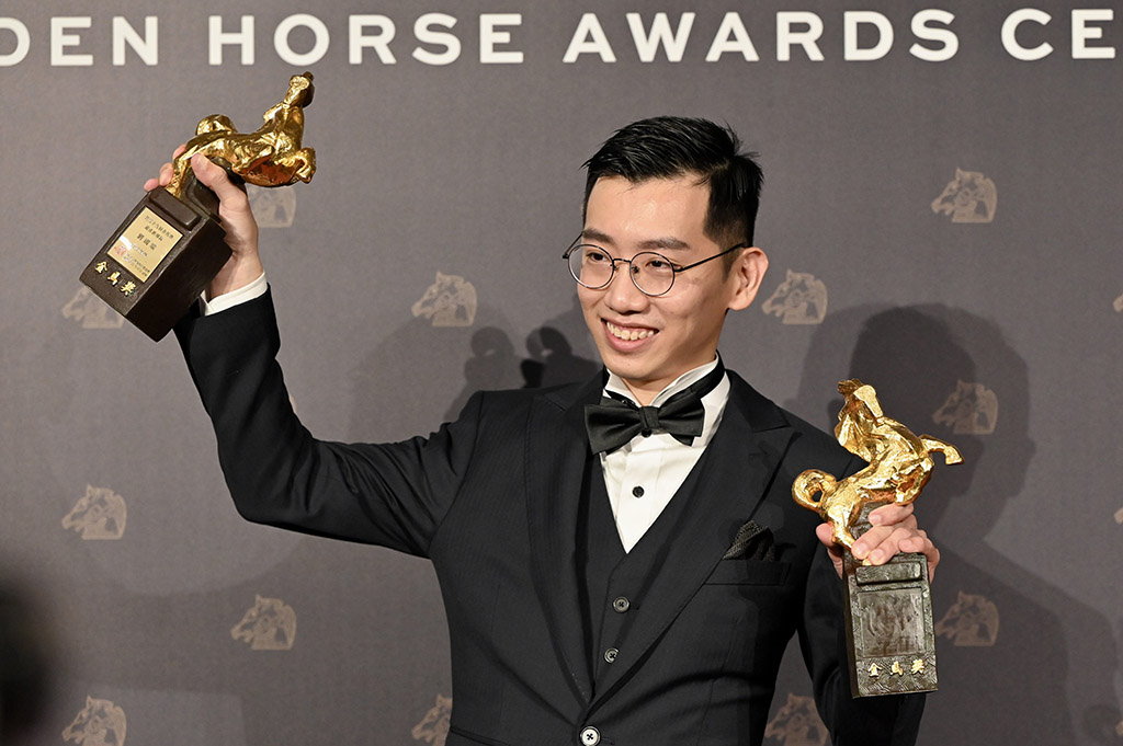 Malaysian director Lau Kok-rui poses for pictures after winning the Best Original Screenplay and the Best New Director awards.