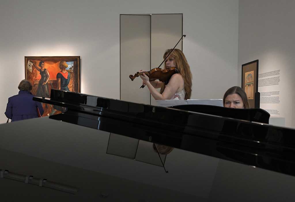 Ukrainian violinist Bhodana Pivnenko and pianist Anna Khmara (right) of 'Touch of Angel' musician group perform during the press preview of 'In the Eye of the Storm' museum.