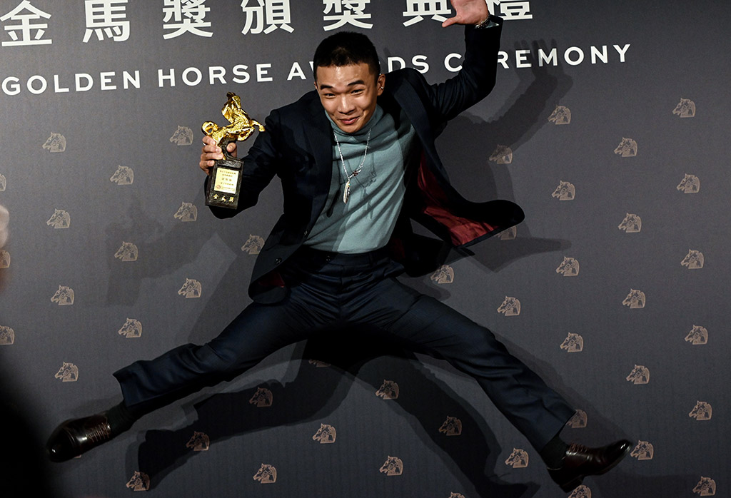 Taiwanese actor Hu Jhih-ciang jumps to celebrate after winning the Best New Performer.