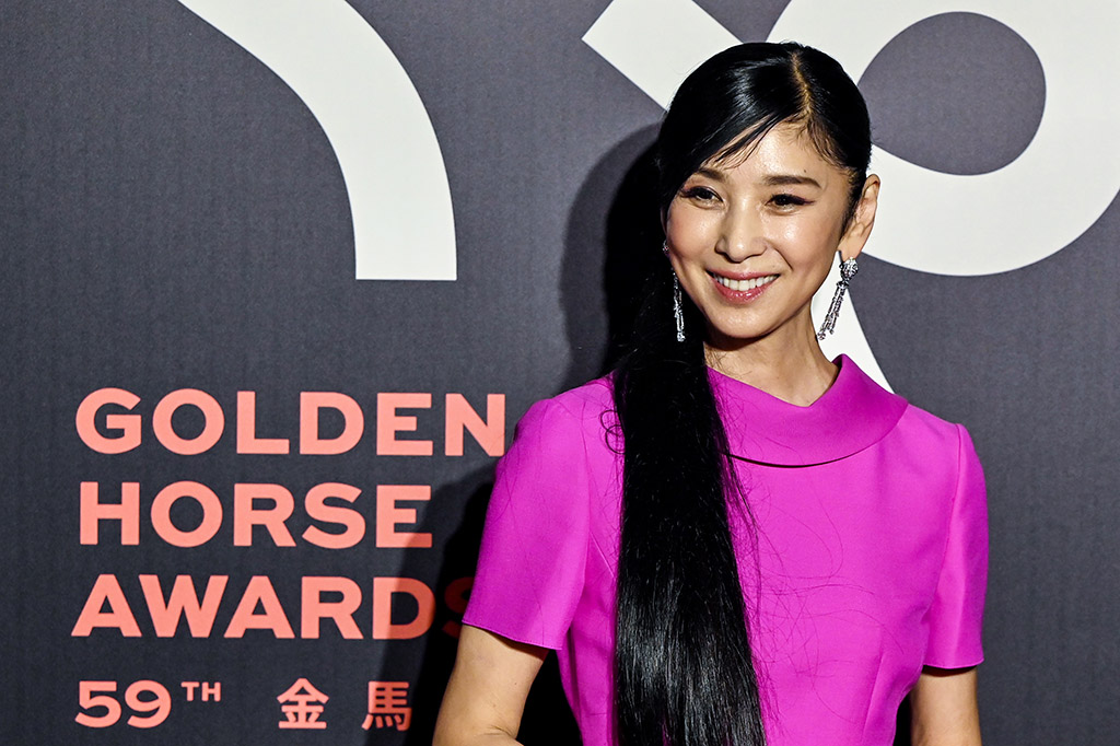 Japanese actress Hitomi Kuroki poses as she arrives at the 59th Golden Horse Film Awards.