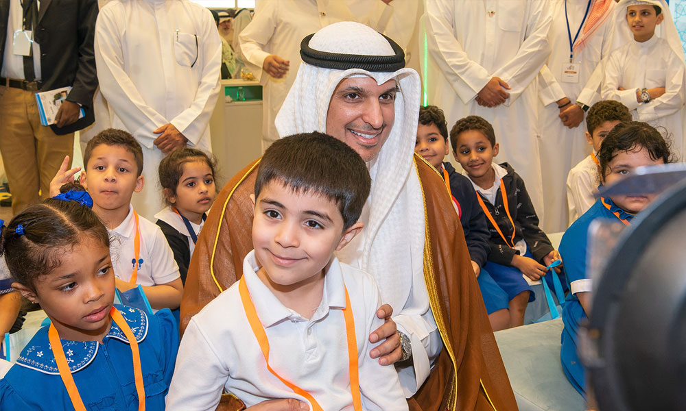 Minister Al -Mutairi with children at the fair ground