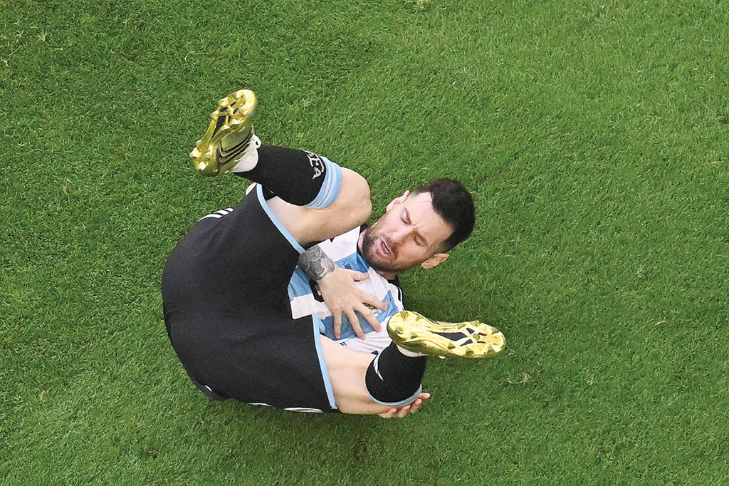 Argentina's forward #10 Lionel Messi reacts after a challenge during the Qatar 2022 World Cup Group C football match between Argentina and Saudi Arabia. - AFP photos