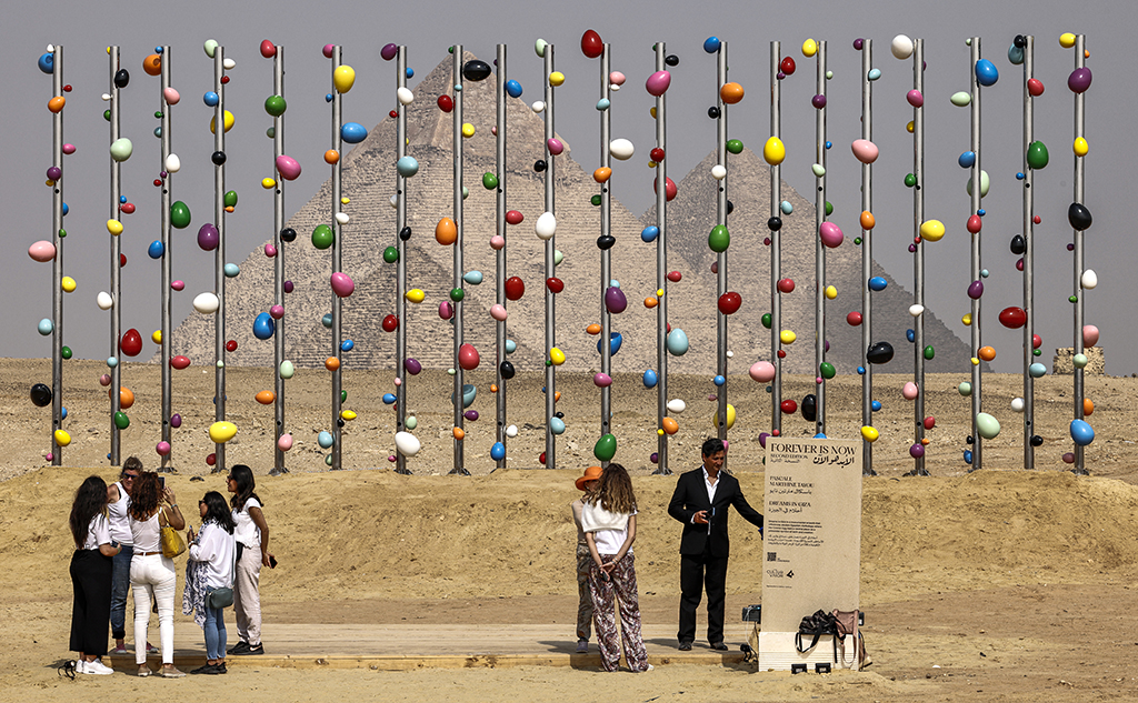 This file photo shows a view of the installation “Dreams in Giza” by Cameroonian artist Pascale Marthine Tayou at the Giza pyramids necropolis during the second edition of the Art D’Égypte exhibition “Forever is Now”. 