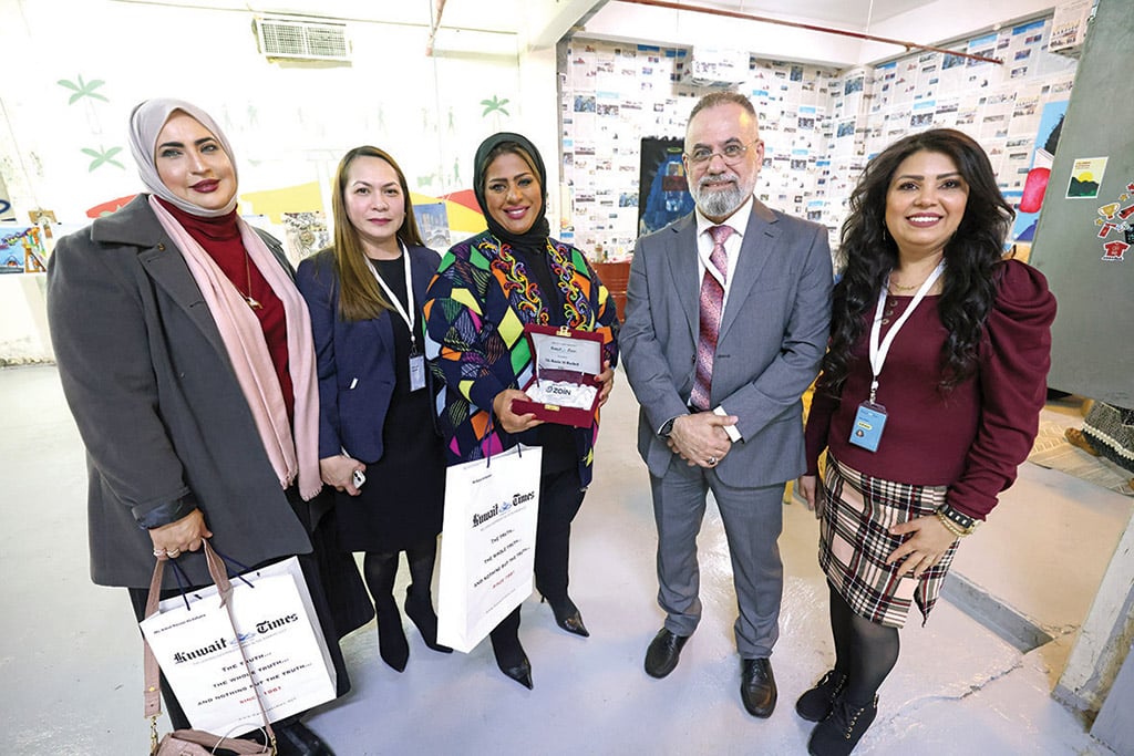 Amal Nasser Al-Jufaira (left), Rachelle De Leon (second left), Executive Secretary - Kuwait Times, Rania Al-Rashed (third left), Advertising and Marketing Manager Taleb Kanjo (second right) and Mary Shaker Gerges, Senior Accountant - Kuwait Times pose during the event.