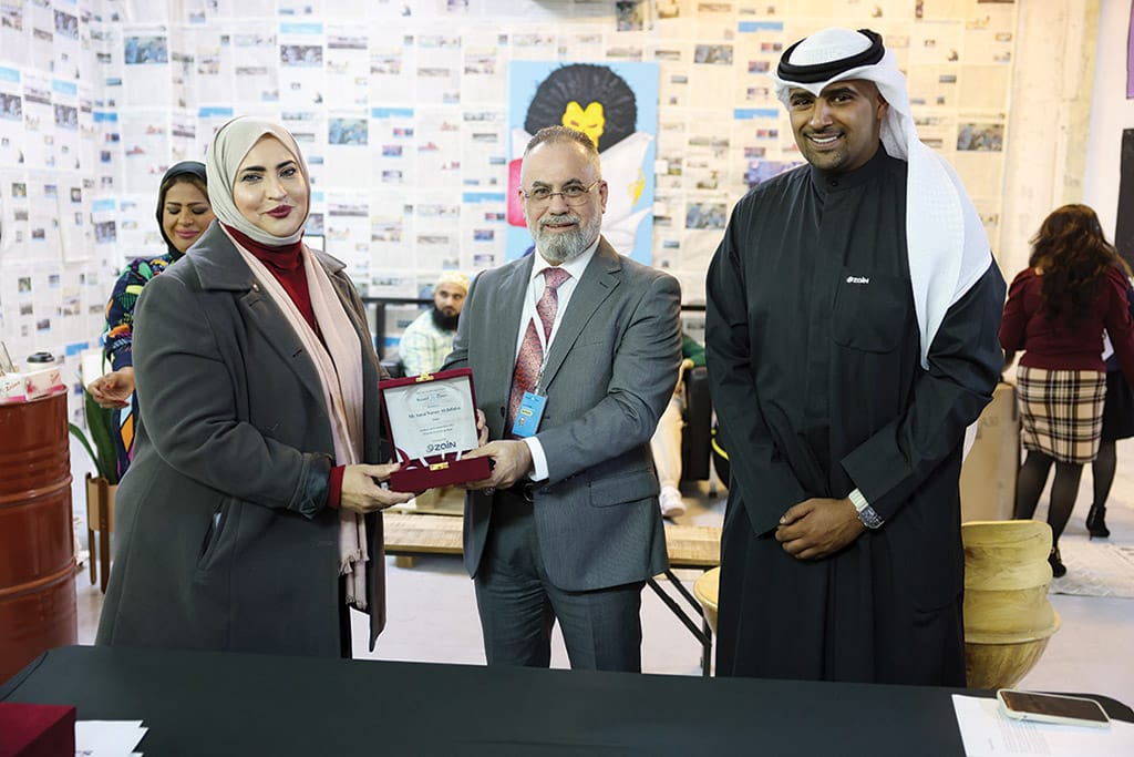 Advertising and Marketing Manager Taleb Kanjo presents a memento to Amal Nasser Al-Jufaira, one of the jury members.