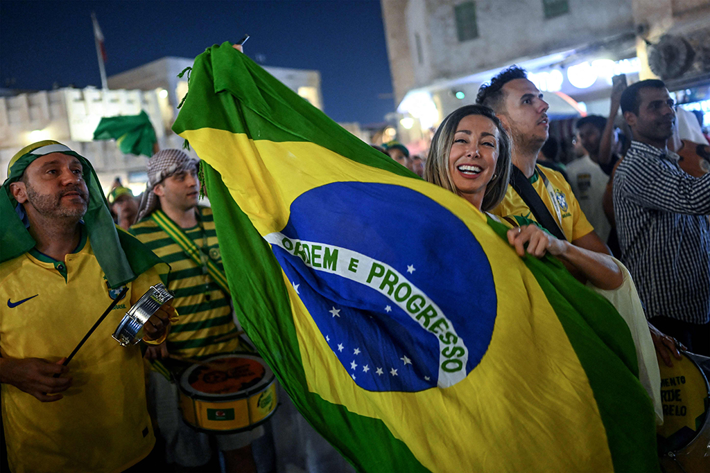 Brazil's supporters celebrate and wave Brazilian flags at the Souq Waqif marketplace. 