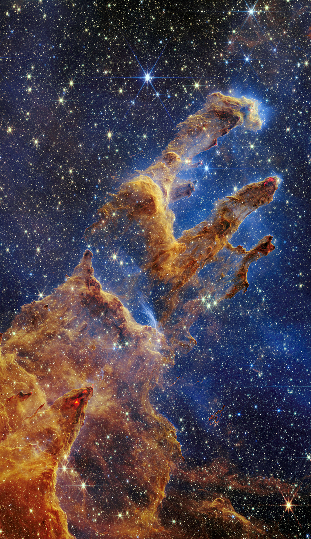 This file handout photo shows the Pillars of Creation that are set off in a kaleidoscope of color in NASA’s James Webb Space Telescope’s near-infrared-light view. 