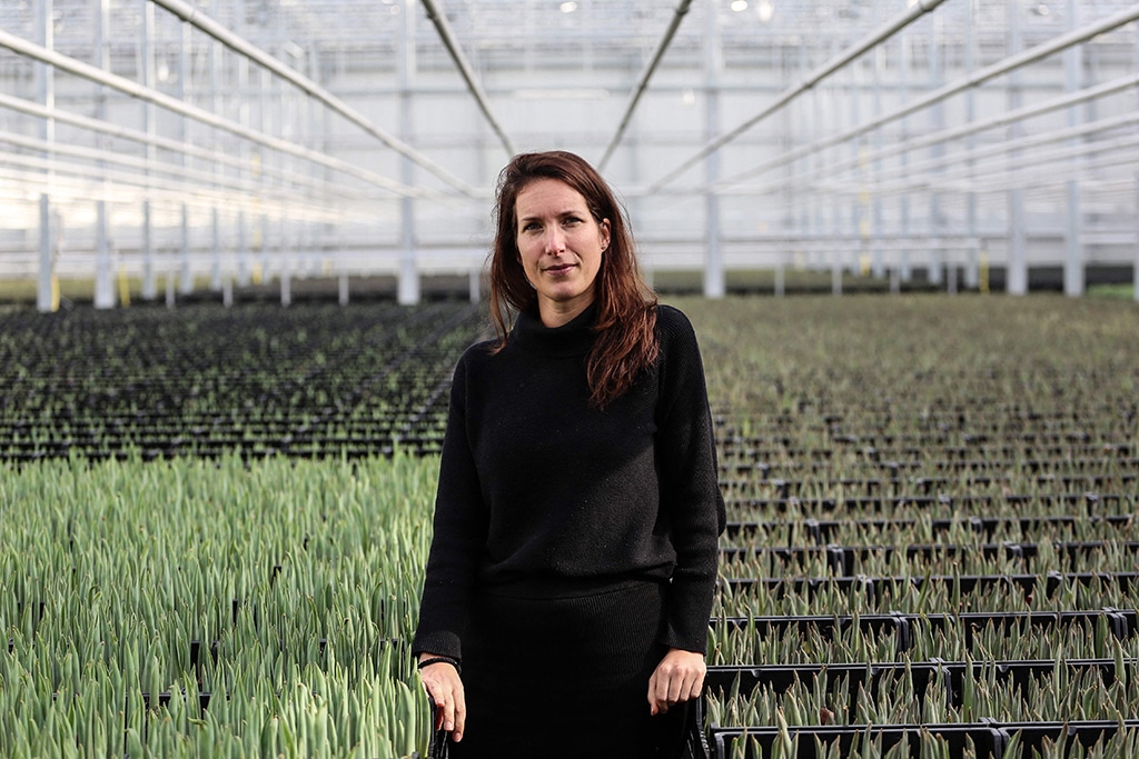 Danielle Koning, 37, a greenhouse worker, poses for a photo among aloe vera plants.