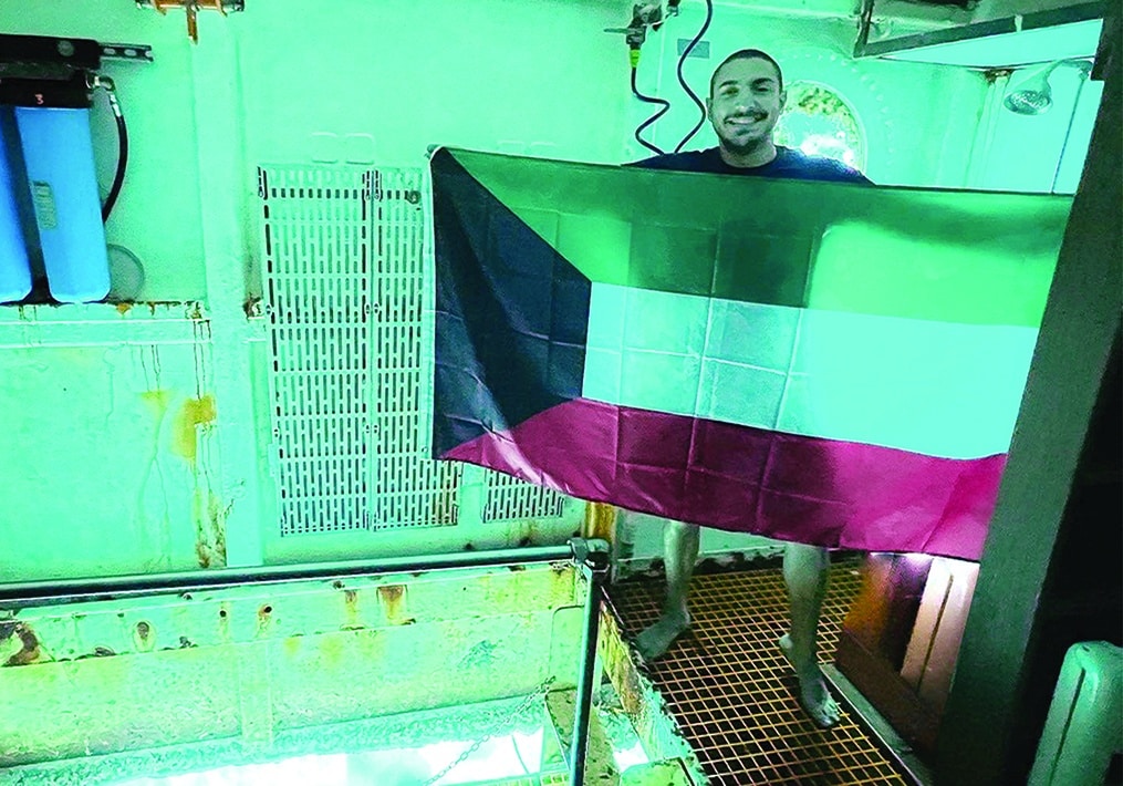 Bader with the Kuwaiti flag at Aquarius Reef Base