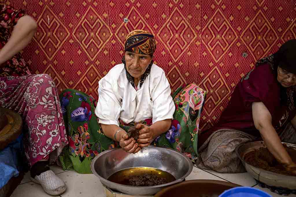 Women squeeze oil out of a paste made from crushed Argan nuts, near Morocco's western Atlantic coastal city of Essaouira.