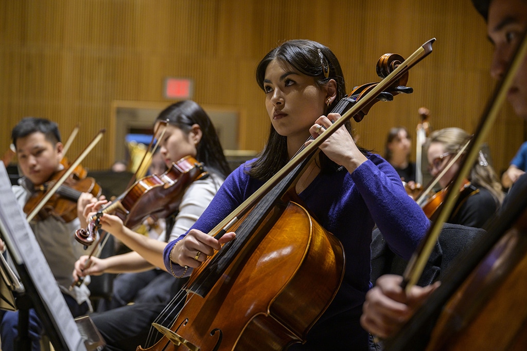 Young cello and violin players with the New York Youth Symphony perform during a rehearsal.