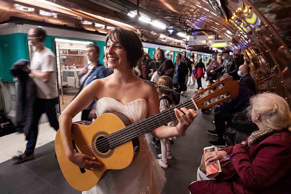 Eli Jadelot, performs in a wedding dress at the subway station “Arts et Metiers” in Paris.