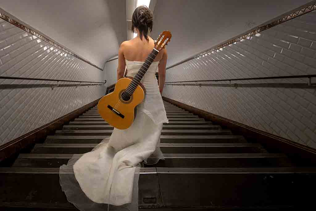 Eli Jadelot, in a wedding dress, walks inside the subway station “Arts et Metiers” in Paris.