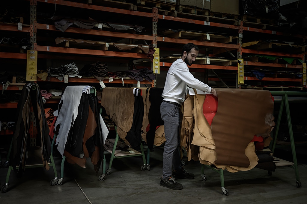 An employee of French shoemaker Weston selects leather at the company's factory in Limoges.