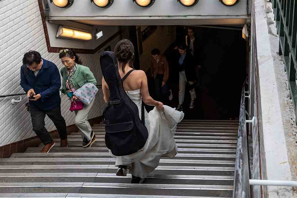 Eli Jadelot, in a wedding dress, enters the subway station “Arts et Metiers” in Paris.