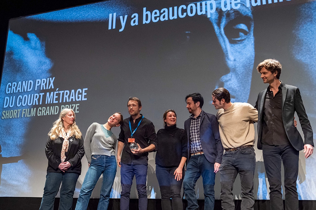 French director Gonzague Legout (third left) poses with his wife, French producer Christina Vieira (fourth left), and jury members (from left) French screenwriter Frederique Moreau, French actress Lou Lampros, French director Francois Descraques, French actor Jules Benchetrit, and French magician David Jarre, after winning the Short Film Grand Prize for his film 