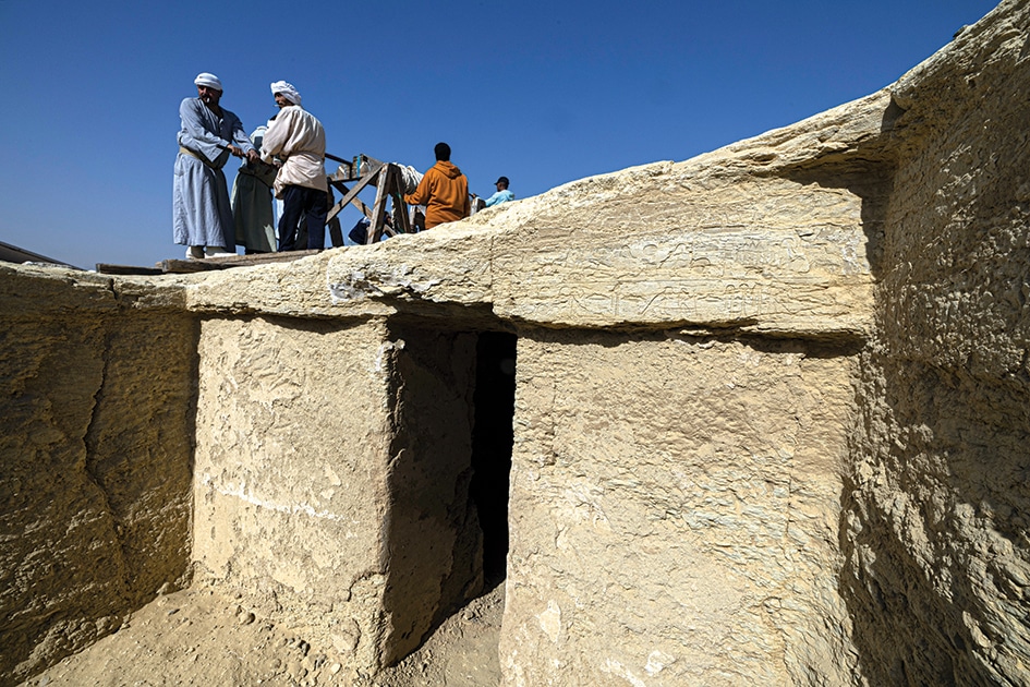 Egyptian workers attend a press conference at the Saqqara archaeological site.
