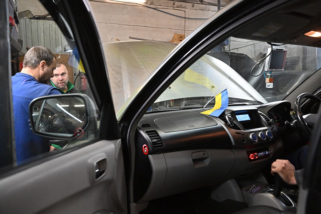 Mechanics work on a van in a auto repairing shop in Ukrainian capital of Kyiv.