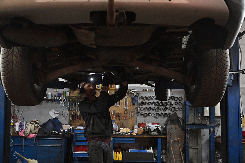 A mechanic works on a van in a auto repairing shop in Ukrainian capital of Kyiv.