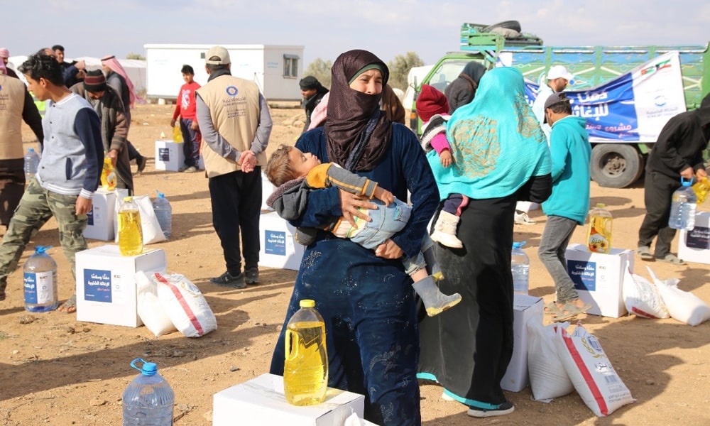 Families at Jordanian refugee camps receive aid from (Warm and Peaceful)