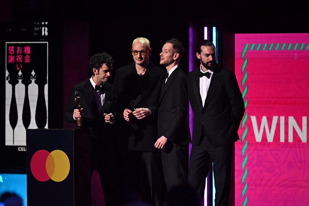 British rock band The 1975 celebrates after receiving the best rock and alternative act of the year award.