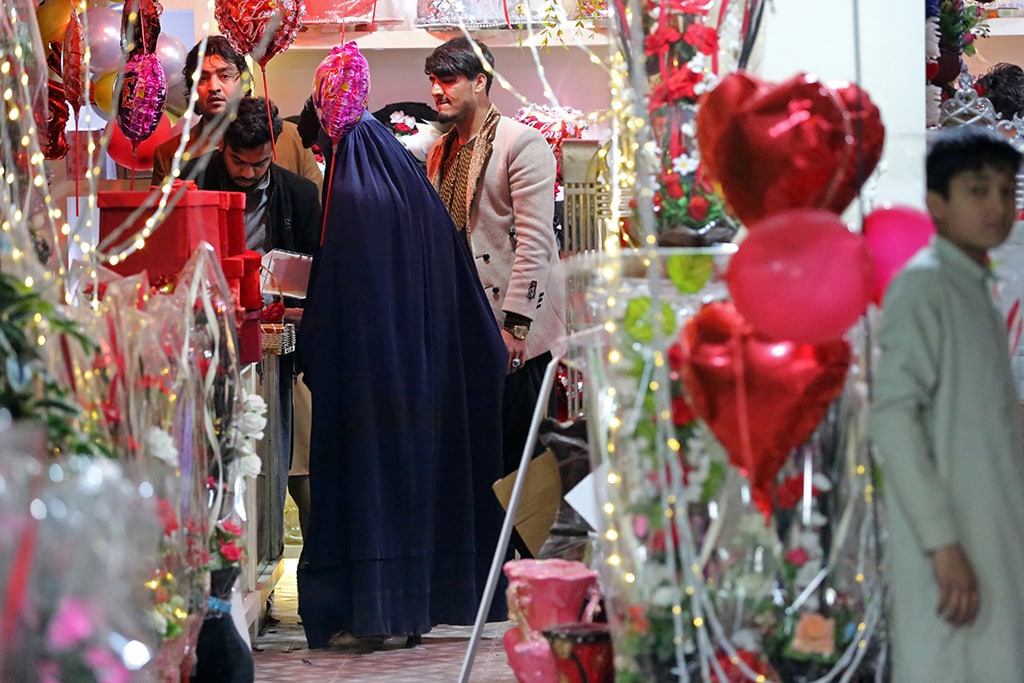 An Afghan burqa-clad woman buys gifts at a shop on the occasion of Valentine's Day in Jalalabad. 