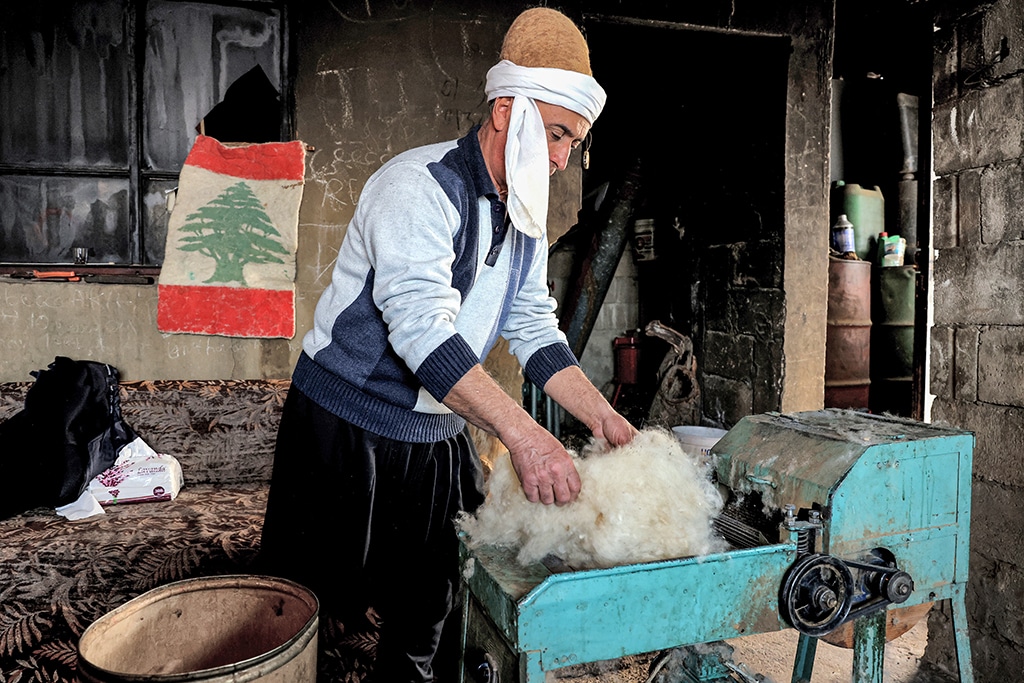 Hatmaker Youssef Akiki inspects the processed sheep’s wool before shaping it into a traditional 