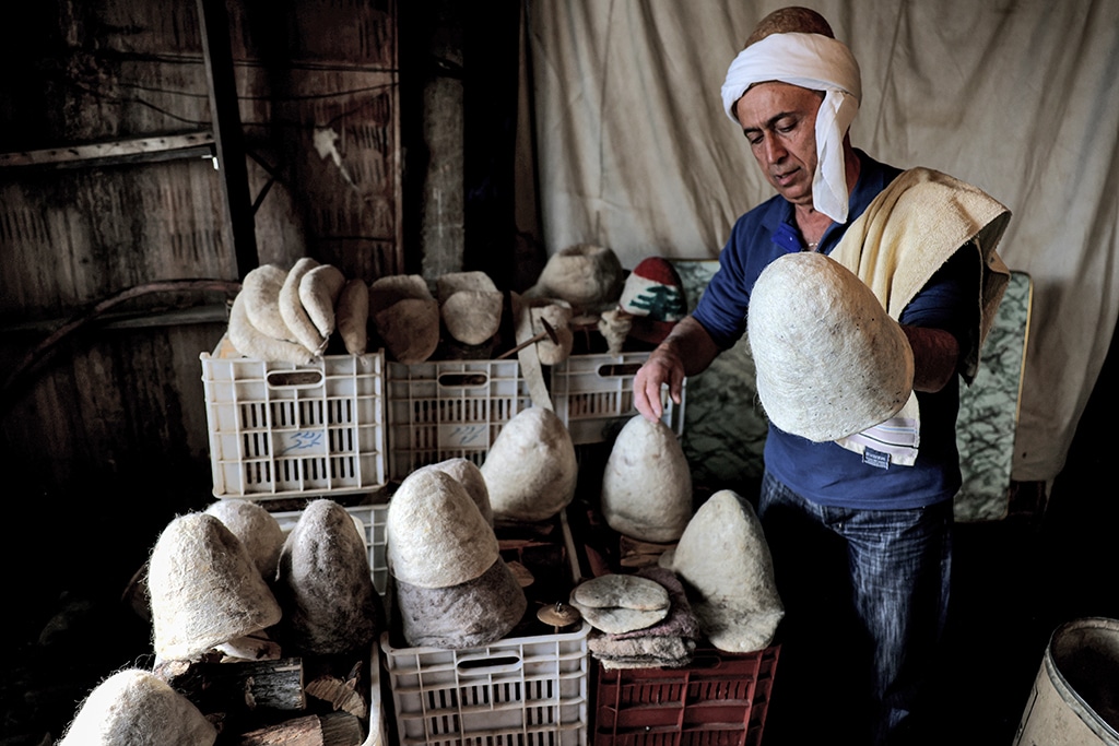 Hatmaker Youssef Akiki inspects some of his traditional 