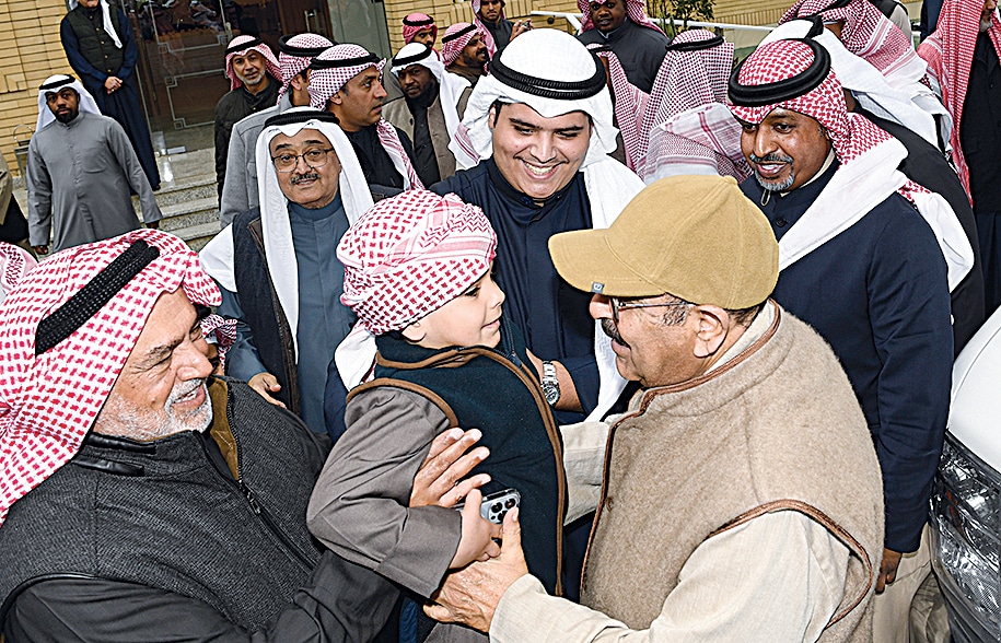 His Highness the Crown Prince Sheikh Mishal Al-Ahmad Al-Jaber Al-Sabah interacts with a child at Azayez farm.