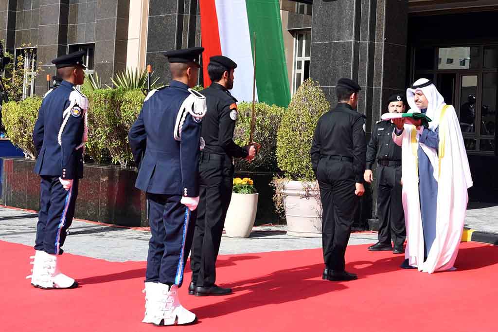 Sheikh Mishal Al-Jaber Al-Abdullah Al-Sabah with the national flag.