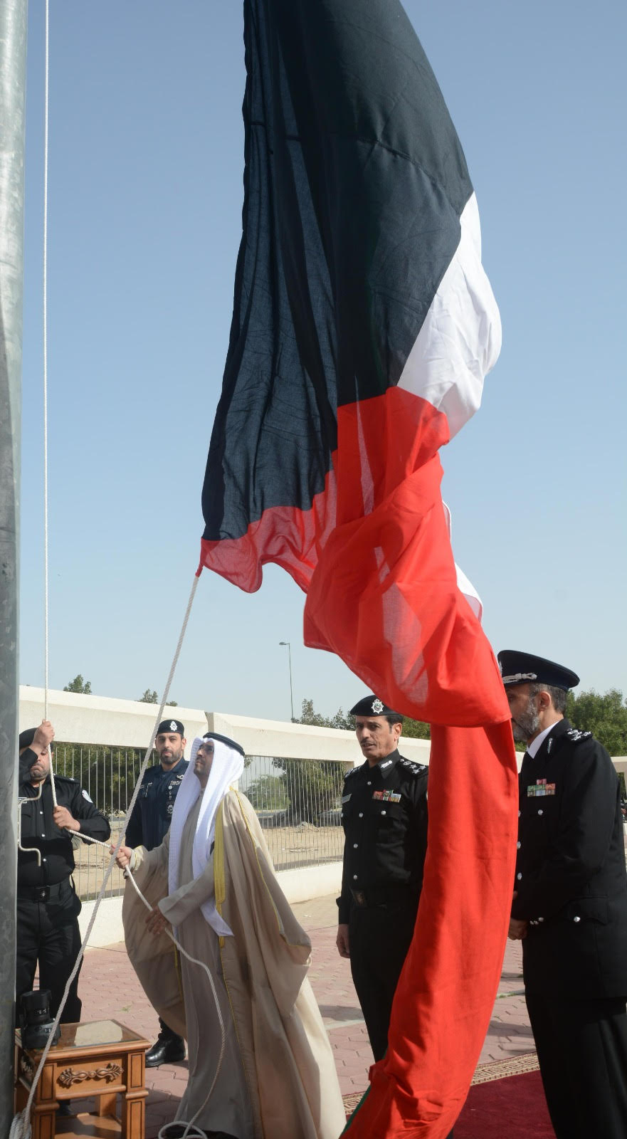 Jahra Governor Nasser Al-Hajraf raising the flag.