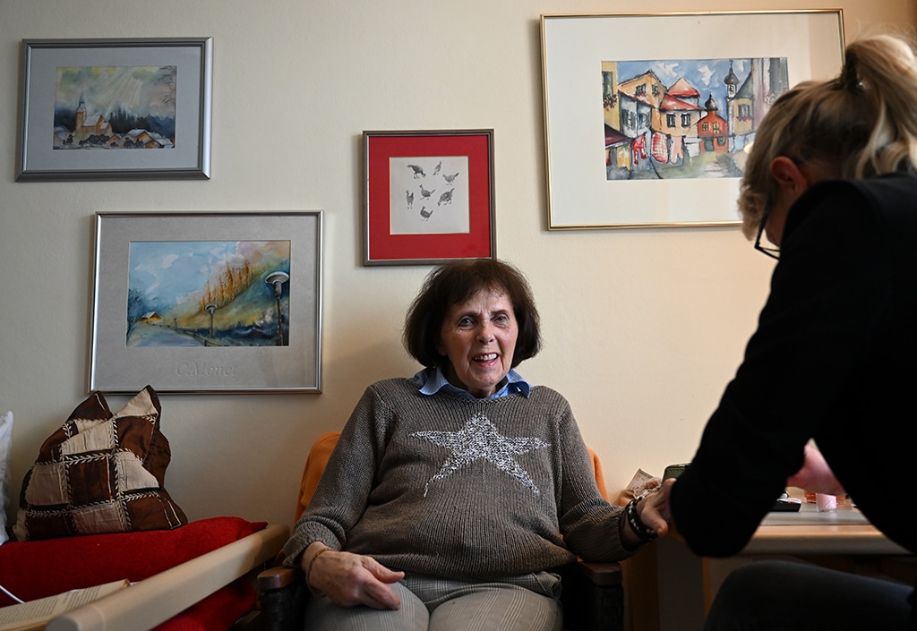 Eva Pioskowik (R) paints the fingernails of Mrs Rohrer (L), at the old people's home in Garmisch-Partenkirchen, southern Germany.