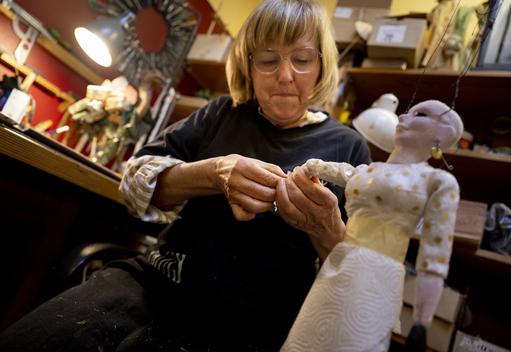 Puppeteer Ursula Winzer works on a puppet prior to the Snow White fairytale puppet show. 