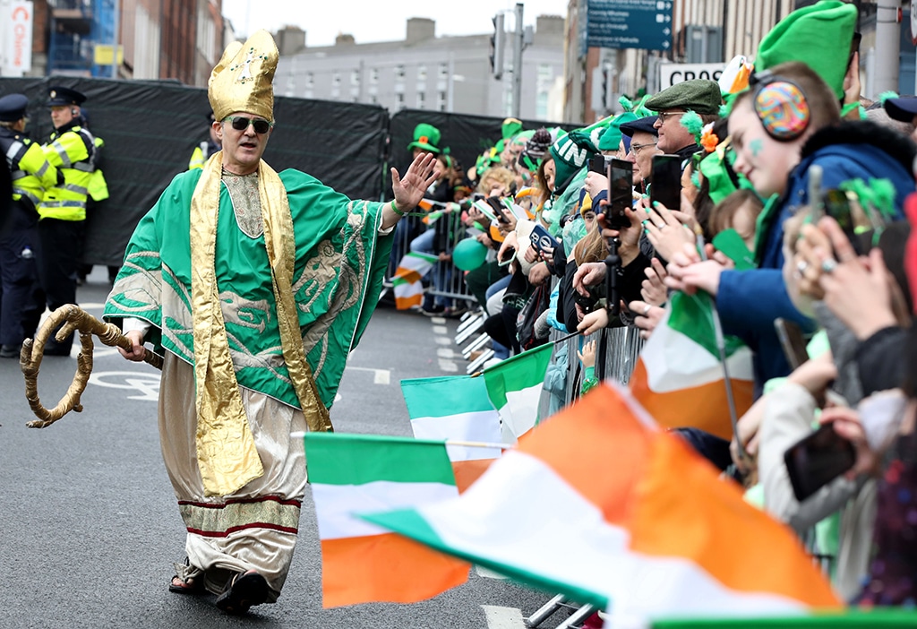 An actor dressed as St Patrick works the crowd as revelers attend the annual St Patrick's Day parade in Dublin.