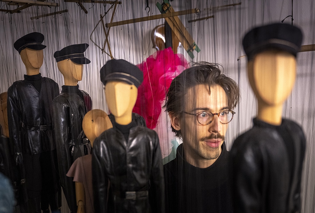 Puppeteer Edouard Funck is seen with faceless puppets in a storage prior to the Snow White fairytale puppet show.