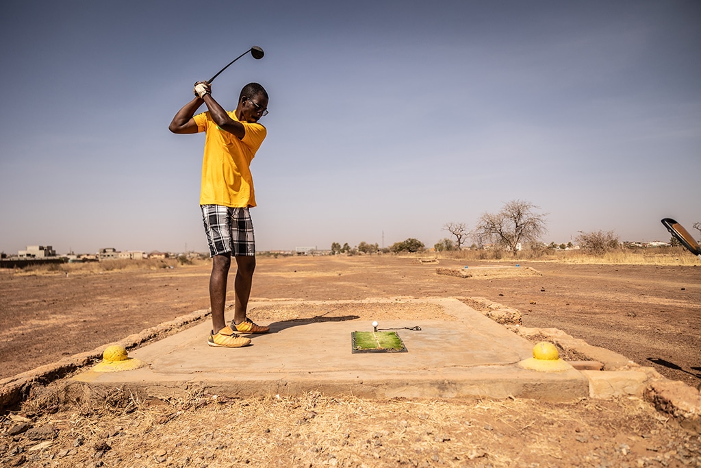 A man plays golf at Ouagadougou's Golf Club.