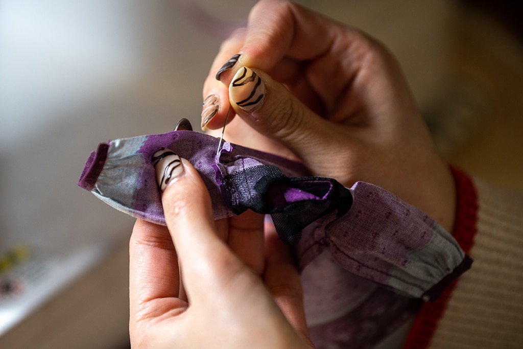 This photo shows Ryoko Baba sewing a costume for her Licca-chan dolls.