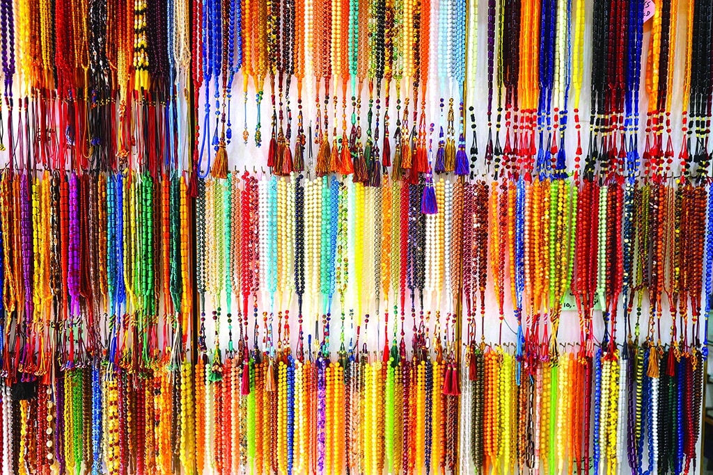 A collection of prayer beads are displayed at a shop.