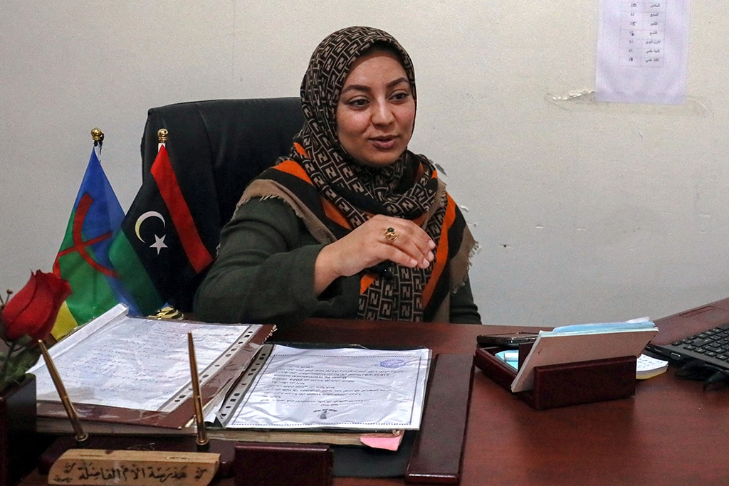 In this picture school director Sondoss Saki gestures at a shool teaching Tamazight language in Zuwara, a majority-Berber community near the border with Tunisia.