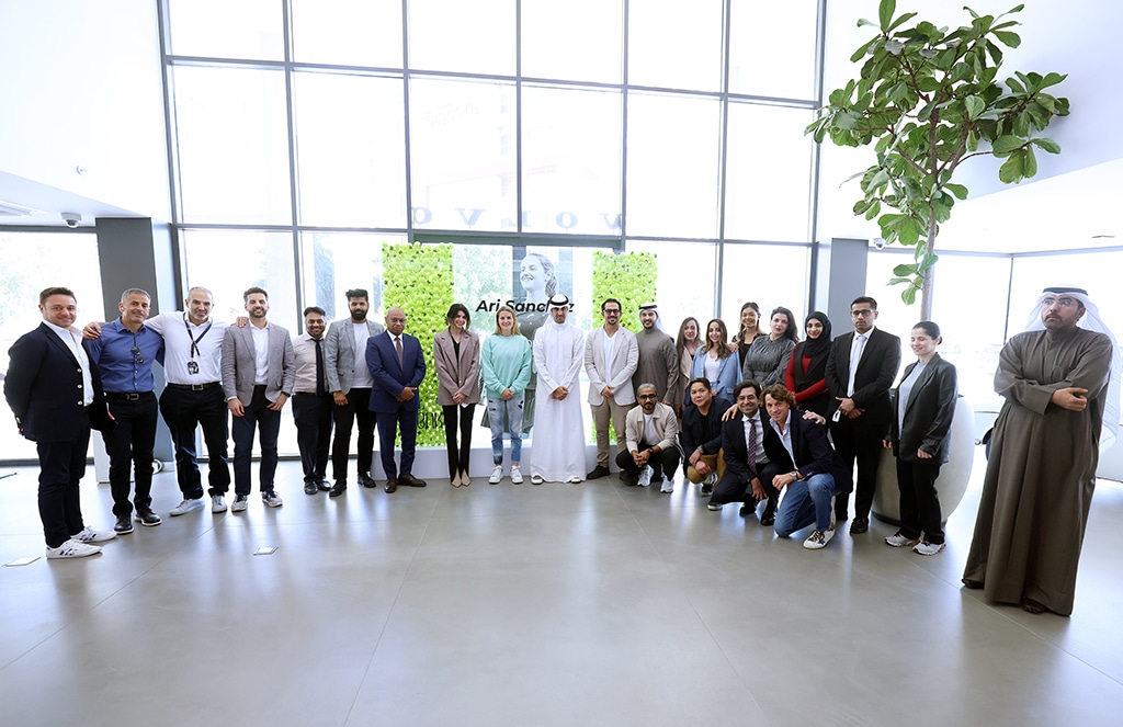 Bader Al-Kharafi (center) poses for a group photo with BNK team.