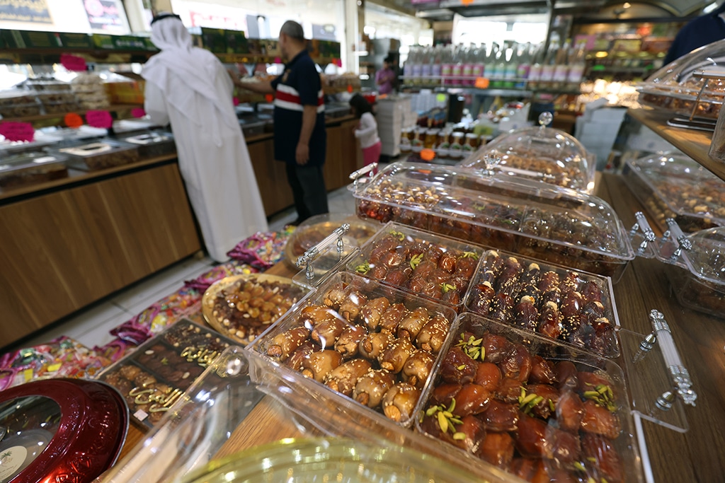 Boxes of dates stuffed with nuts and other ingredients are displayed at a shop in Kuwait City on April 1, 2023.